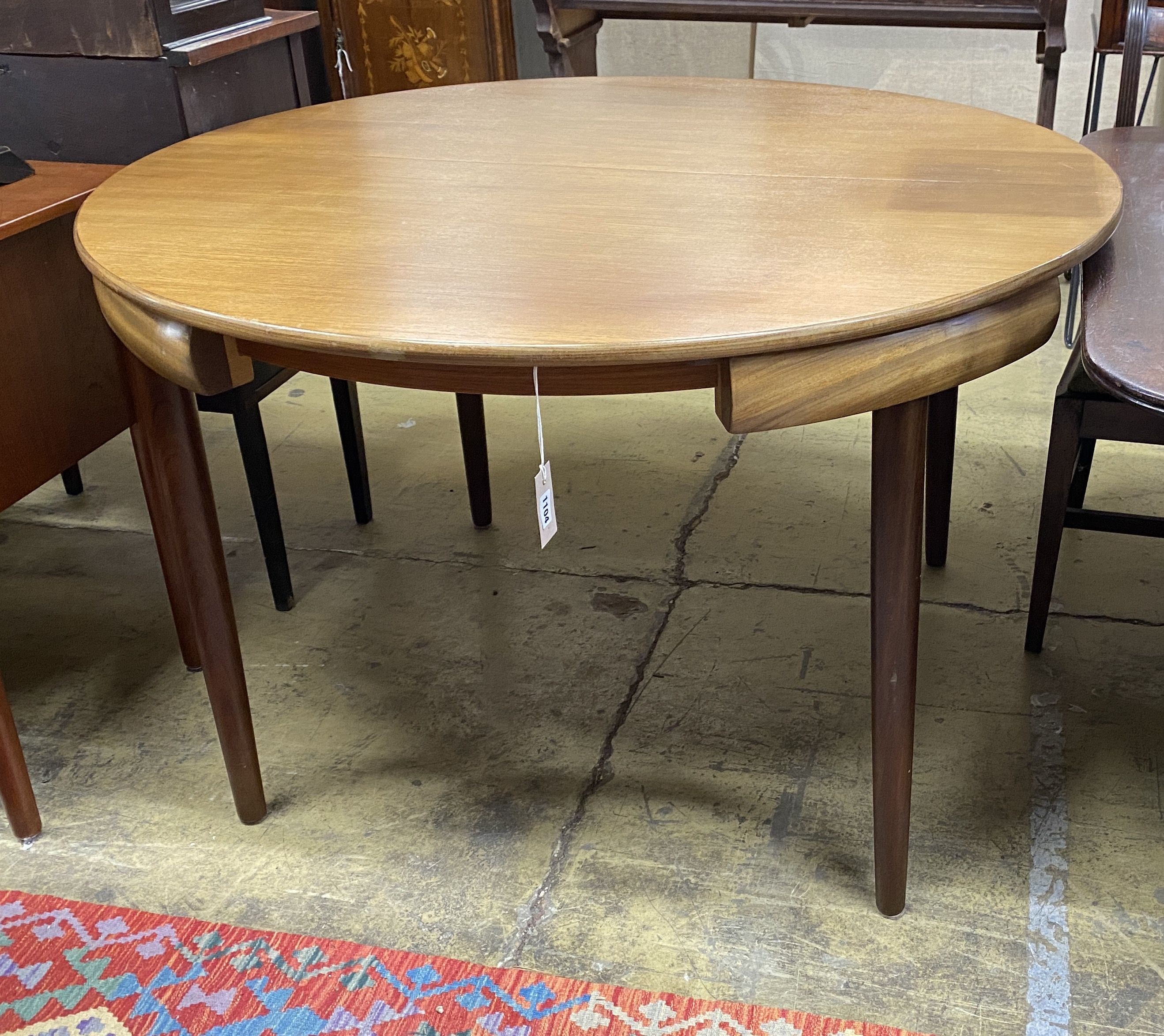 A mid century design Frem Rojle Roundette extending circular teak dining table, diameter 120cm, height 74cm